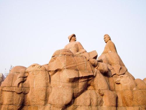 a statue of two men sitting on a rock formation at Atour Hotel Xi'an High Tech Dazhai Road in Xi'an