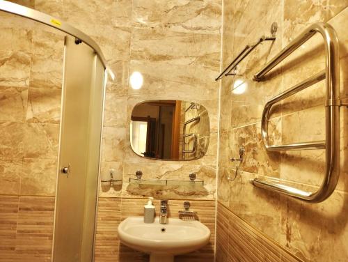 a bathroom with a sink and a mirror at Уютный уголок Фрунзе in Bishkek