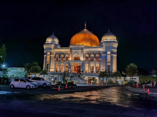 a large building with a gold dome on top of it at OYO Living 3091 Apt The Suites Metro By Ananda in Bandung