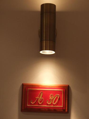a light and a red sign on a wall at Hotel Avra in Kardítsa