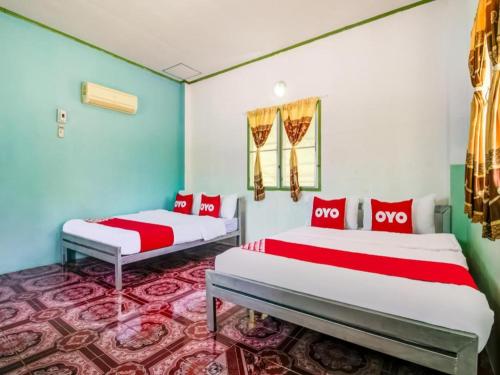 Postel nebo postele na pokoji v ubytování OYO 1080 Kanyapa Resort Kaeng Krachan