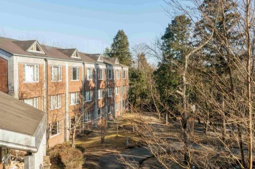 an apartment building with trees in front of it at Fuji Shoei kaikan in Fuji