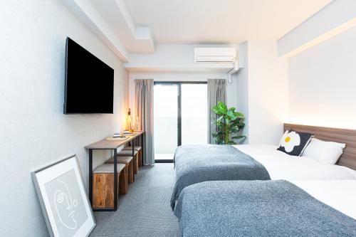 Postel nebo postele na pokoji v ubytování Living like Hotel 博多駅南