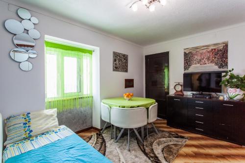 a bedroom with a bed and a table and a tv at Apartamento Cardoso in Albufeira