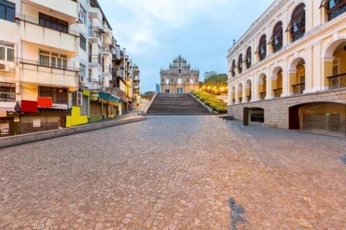 an empty street in a city with buildings at London Hotel in Macau