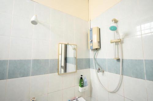 a bathroom with a shower and a sink at OYO Homes 90575 CK Bahau Homestay in Bahau