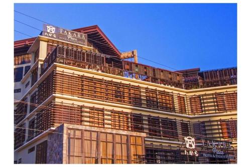 a building with a sign on top of it at Capital O 897 Takara Hotel And Events Place in Calamba