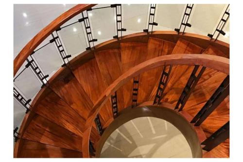 an overhead view of a wooden spiral staircase at Capital O 897 Takara Hotel And Events Place in Calamba