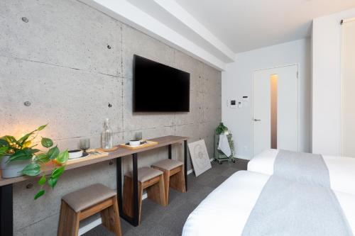 Postel nebo postele na pokoji v ubytování Living like Hotel 博多駅南