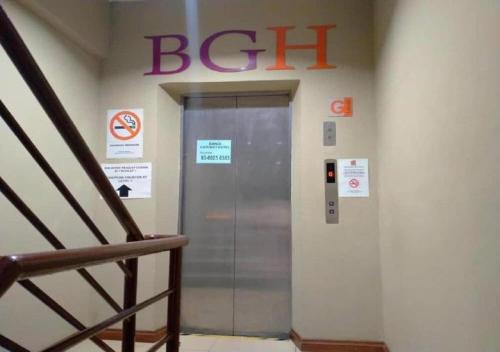an elevator in a building with a sign on the wall at BANGI GATEWAY HOTEL in Kuala Lumpur