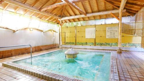 a large swimming pool with a fountain in a building at Ooedo Onsen Monogatari Minoh Kanko Hotel in Minoo