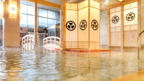 a flooded room with water on the floor at Ooedo Onsen Monogatari Minoh Kanko Hotel in Minoo