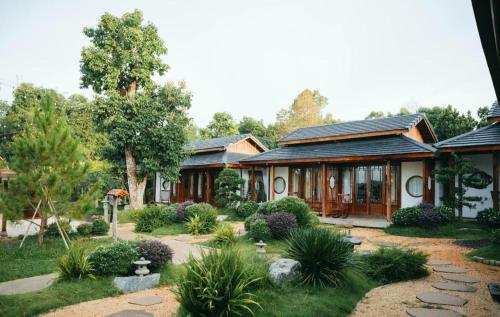 a house with a garden in front of it at Jun's Home in Buon Ma Thuot
