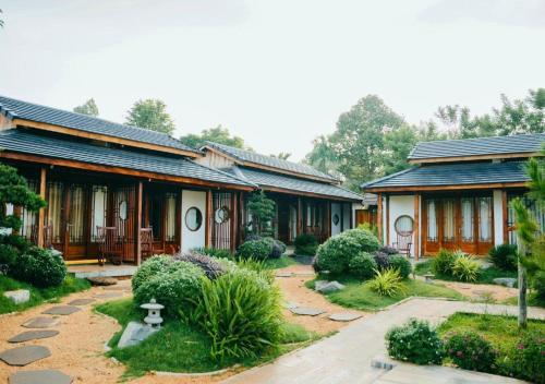 a house with a garden in front of it at Jun's Home in Buon Ma Thuot