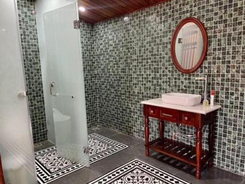 a bathroom with a sink and a mirror at Jun's Home in Buon Ma Thuot