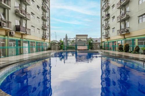 a pool of water between two buildings at OYO 94150 Gateway Apartment Pasteur By Eldian in Bandung