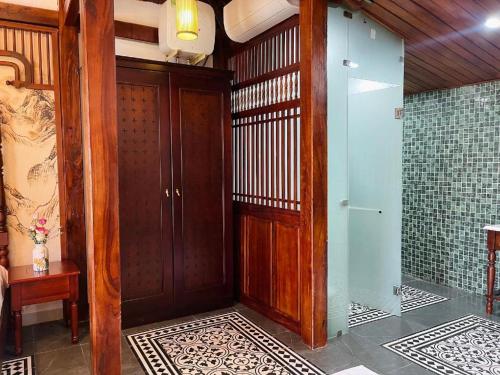 a wooden door in a room with tiles on the floor at Jun's Home in Buon Ma Thuot