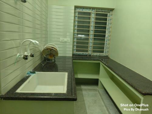 a bathroom with a sink and a window at Annamaiah Premium & Grand - 2 & 3 BHK Apartments for Families - Homestay & Home Food Service in Tirupati