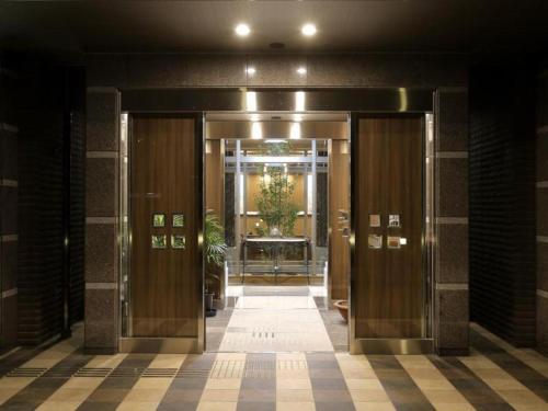 a hallway of a building with the doors open at Hotel Sunoak Kashiwanoha in Kashiwa