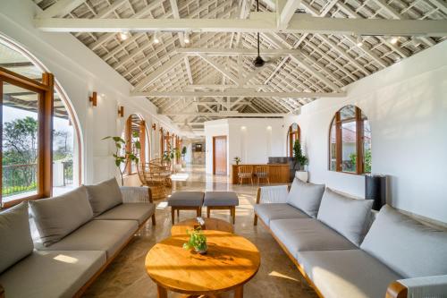 a living room with couches and a table at Arpana Luxury Private Pool Villas in Jimbaran
