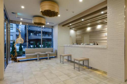 a lobby with benches and a counter in a building at Hotel IL FIORE Kasai in Tokyo