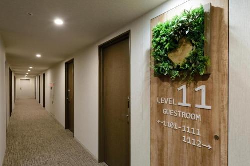a hallway with areath on the wall of a building at Hotel IL FIORE Kasai in Tokyo