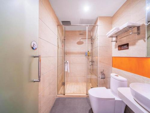 a bathroom with a shower with a toilet and a sink at 7 Days Premium·Guangan Chaoyang Avenue in Guang'an