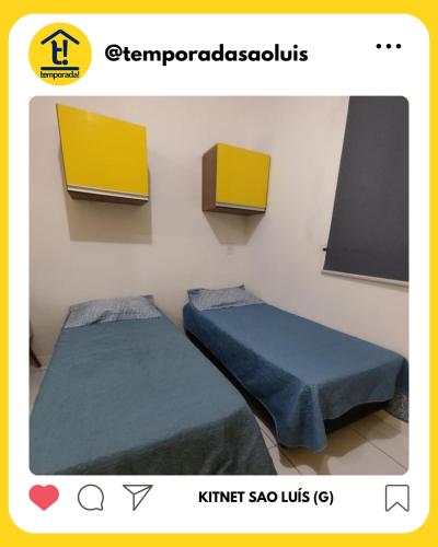 a room with two beds and a tv at Kitnet São Luís - Studio G in São-José-do-Ribamar