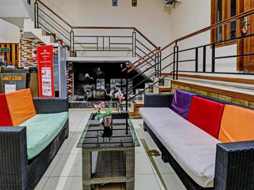 a store with colorful couches and a table with flowers at OYO Life 92127 Skyland Pasteur in Bandung