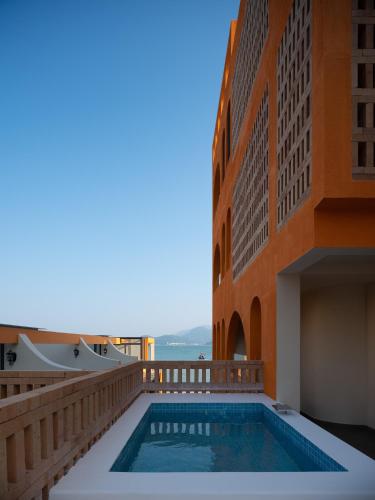 a swimming pool in the middle of a building at Mengyuan Bian Seaview Private Hot Spring Vacation Courtyard (Jiaochangwei Beach Branch) in Dapeng