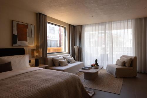 a bedroom with a bed and a chair and a window at Mengyuan Bian Seaview Private Hot Spring Vacation Courtyard (Jiaochangwei Beach Branch) in Dapeng