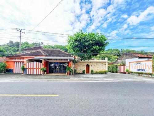 a building on the side of a road with a street at Hotel Family Syariah 1 Parangtritis RedPartner in Parangtritis