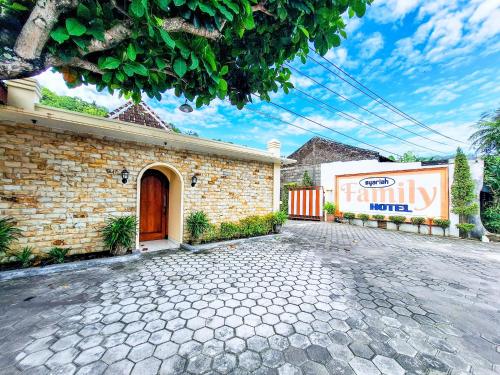 a brick building with a sign on the side of it at Hotel Family Syariah 1 Parangtritis RedPartner in Parangtritis