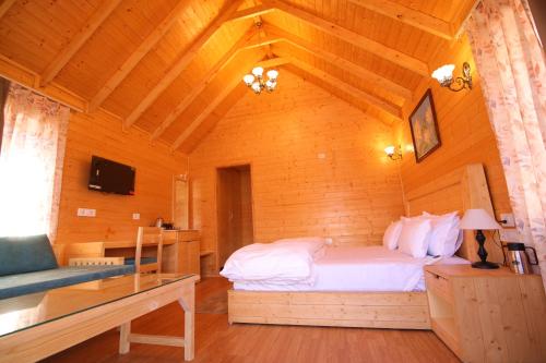 a bedroom with a bed in a wooden cabin at The Auli Meadows in Joshīmath