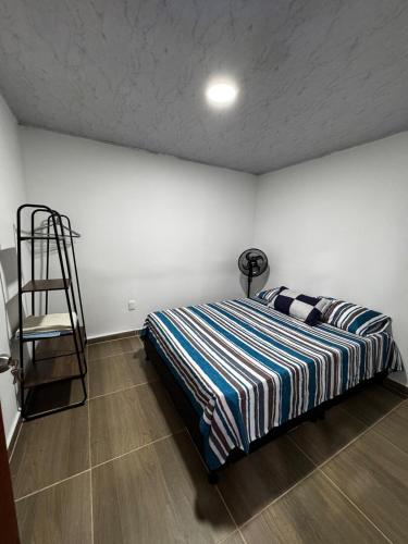 a bedroom with a bed and a ladder in it at Casa con Parrilla y Espacios al Aire Libre in Acacías