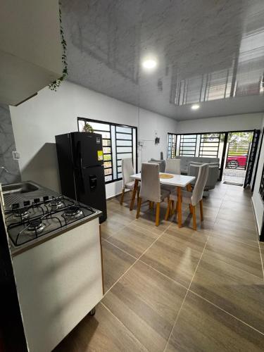 a kitchen with a stove and a table with chairs at Casa con Parrilla y Espacios al Aire Libre in Acacías