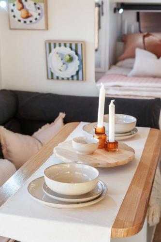 a table with plates and candles on top of it at Vineyard Farmstay at Vista Fiano in Clare