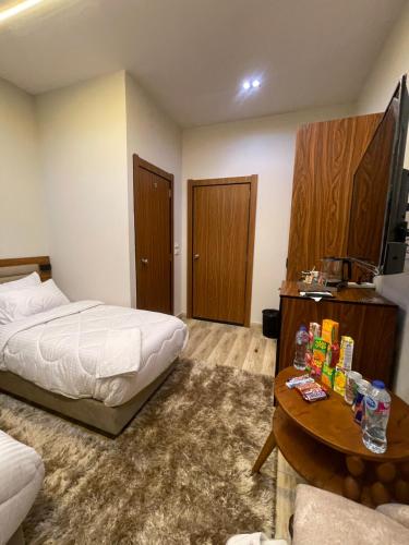 a hotel room with two beds and a table and a coffee table at Italia Hotel cairo in Cairo