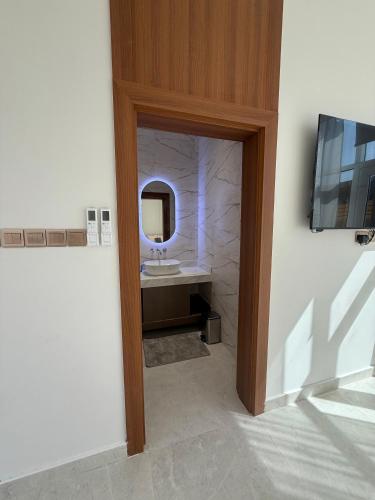 a bathroom with a sink and a mirror at Lavender chalet in Qurţah