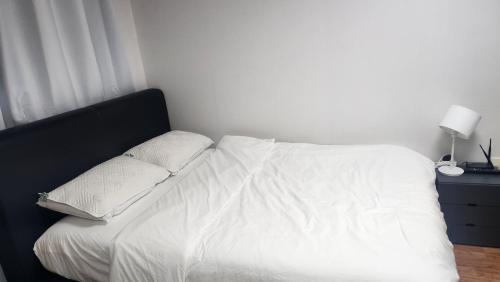 a white bed with two pillows on top of it at Kiman09 in Seoul