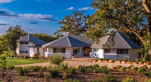 a white house with a blue roof at Meadows Estate in Bangalow
