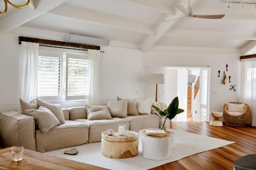 a living room with a couch and a table at Meadows Estate in Bangalow