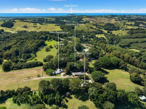 an aerial view of a park with trees and the ocean at Meadows Estate in Bangalow