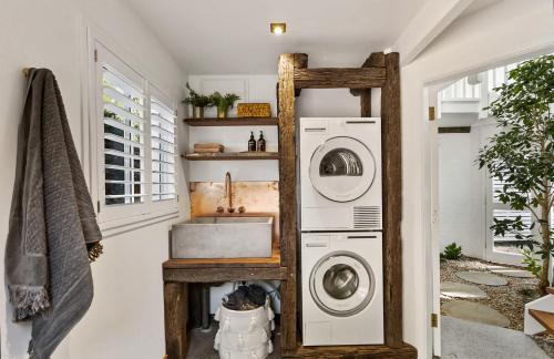 a laundry room with a sink and a washing machine at Meadows Estate in Bangalow