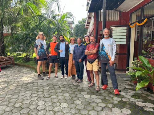 a group of people standing in front of a building at Butterfly Lodge in Pokhara