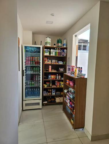 a kitchen with an open refrigerator with drinks at Compact Time apto 406 Lindo Flat in João Pessoa