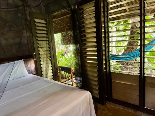 a bedroom with a bed and a window at LOA Stay in Surigao