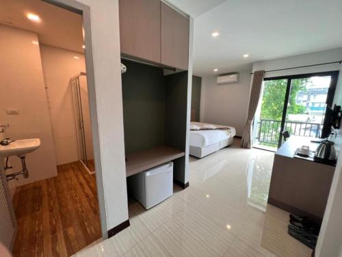 a room with a bedroom with a bed and a bathroom at Baan Nan B&B Hotel in Nan