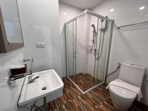 a bathroom with a shower and a sink and a toilet at Baan Nan B&B Hotel in Nan