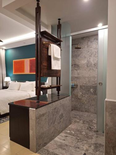 a bathroom with a bed and a shower in a room at The Interlude Art Retreat in Hoi An